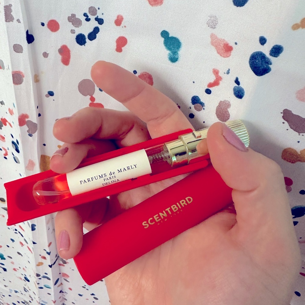 “Delina” by Parfums de Marly Scentbird .27 fl oz vial with red atomizer case